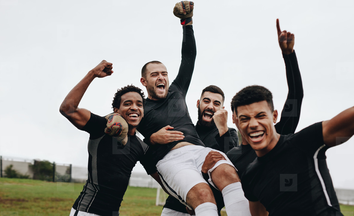 soccer players celebrating victory